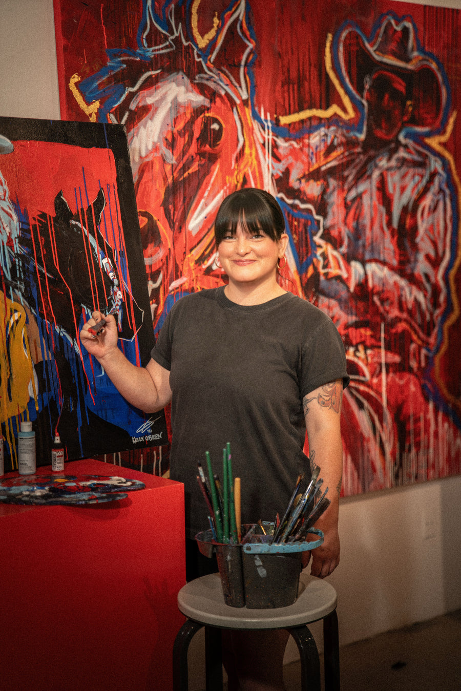 Kelly O'Brien talking about her work in front of one of her paintings